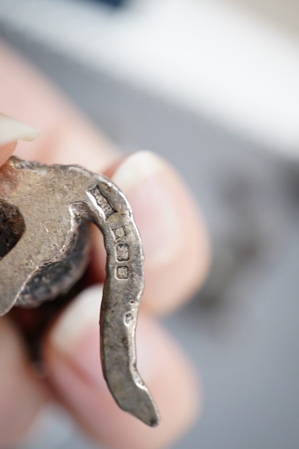 An Elizabeth II silver four piece miniature cat band by S.J. Rose & Son, Birmingham, 1976, tallest 58mm, together with a modern 925 miniature model of a standing grizzly bear and a modern silver model of a kitten(filled)